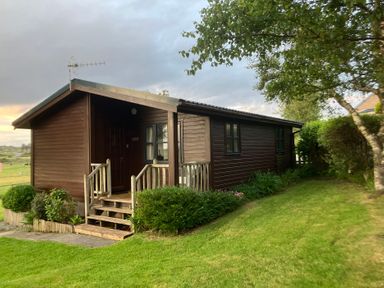 A cabin with steps and windows at Island View Lodge Back of Keppoch near Arisaig