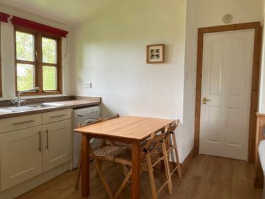 A kitchen with a sink and a table at Island View Lodge Back of Keppoch near Arisaig