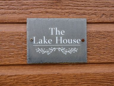A sign reading The Lake House mounted on a wooden wall at The Lake House in Marston near Barkston