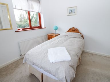 A bedroom with a single bed side table and window at Kerangarth in Corbridge