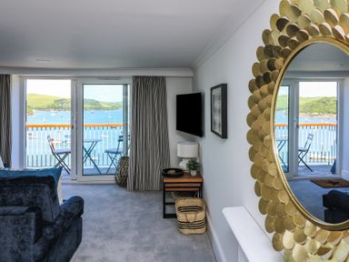 A living room with a view of the water at 43 The Salcombe in Salcombe