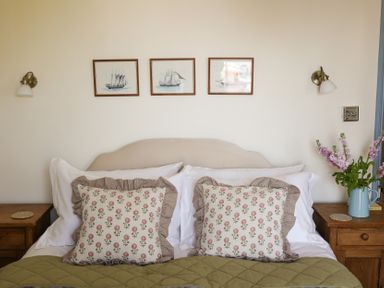 A bedroom with a bed and pillows at Kittiwake in Newlyn