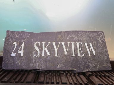 A slate sign with the number 24 and the text Skyview