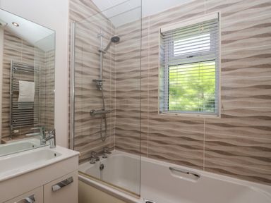 A bathroom with a bathtub and shower at Skyview in Newton Ferrers