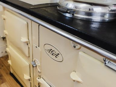 An AGA cooker with a black cooking surface in the kitchen at Cheviot Manor, Akeld near Wooler