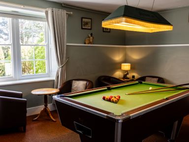 A snug with a pool table and seating at Cheviot Manor near Wooler