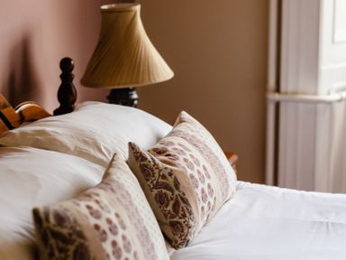 A bedroom with a bed and lampshade at Cheviot Manor in Akeld near Wooler