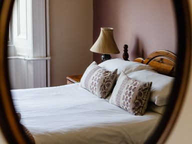 A bedroom with a bed and lamp at Cheviot Manor Akeld near Wooler