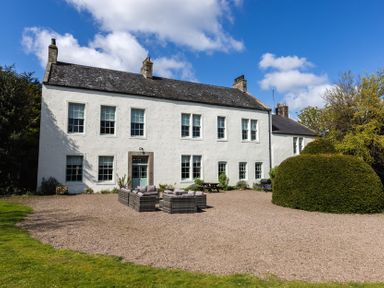 An outdoor seating area in front of a house at Cheviot Manor Akeld near Wooler
