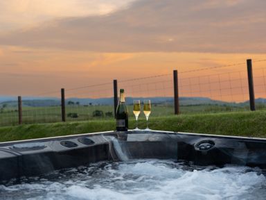 A hot tub with champagne and glasses at Golygfa Cwrt near Bontgoch and Penrhyncoch