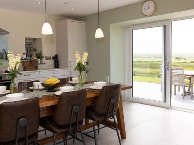 A kitchen with a dining table and chairs at Golygfa Cwrt near Bontgoch and Penrhyncoch