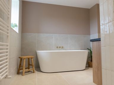 A bathroom featuring a bathtub and stool at Golygfa Cwrt near Bontgoch and Penrhyncoch