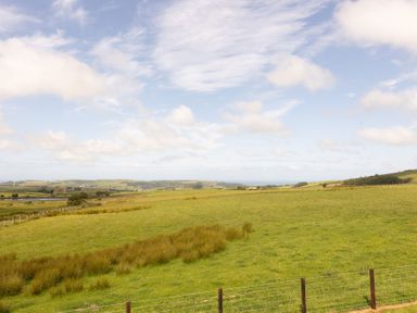 A grassy landscape with hills and clouds at Golygfa Cwrt Near Bontgoch and Penrhyncoch