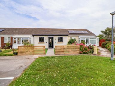 A house with a front door, windows, and garden at 4 Willow Grove - Freehold in Talacre