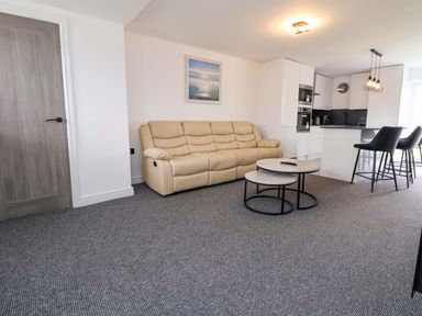 A living room with a sofa and coffee table at 4 Willow Grove - Freehold Talacre