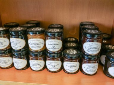 Jars of Raydale Preserves including jelly marmalade and jam on wooden shelves at Charlottes in Holbeach