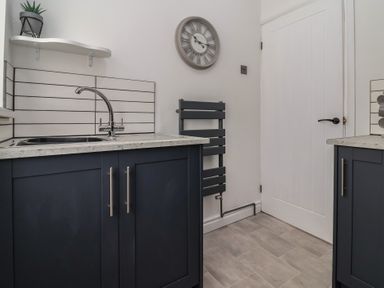 A kitchen with a sink and countertops at Driftwood in Rhyl