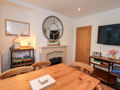 A dining room with a table and chairs at Highfield Cottage in Windermere