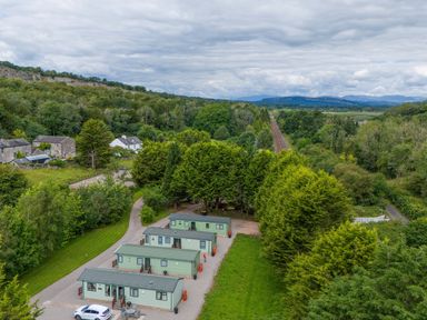 A view of cabins in a natural setting with trees and train tracks at Lodge 1 Silverdale