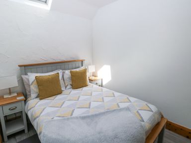 A bedroom with a double bed two bedside tables and lamps at 3 The Barn in Haverfordwest