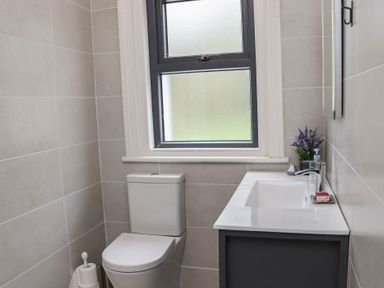 A bathroom with a toilet sink and window at Heatherbell House Ballyhoura near Buttevant