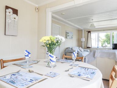A dining room with a table set for meals at Lazy Days in St Merryn