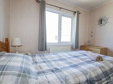 A bedroom with a bed and lamp at Lazy Days St Merryn