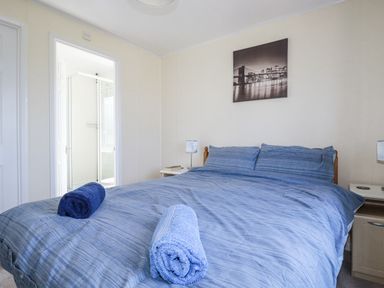 A bedroom with a bed and towels on it at Lazy Days St Merryn