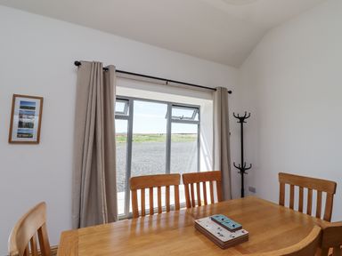 A dining room with a table and chairs at West Burton Hemmel Bamburgh