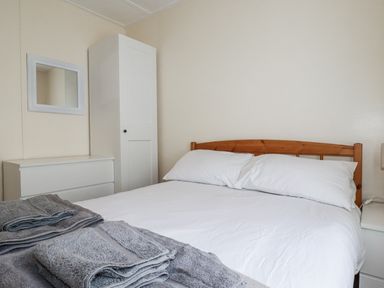 A bedroom with a bed and wardrobe at Sea Ledge in Tintagel