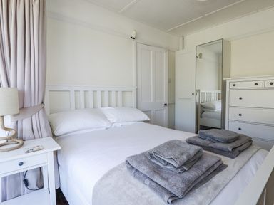 A bedroom with a bed and towels on top at Sea Ledge in Tintagel