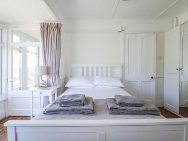 A bedroom with a bed and towels on it at Sea Ledge in Tintagel