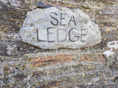 A stone with the inscription SEA LEDGE at Sea Ledge in Tintagel