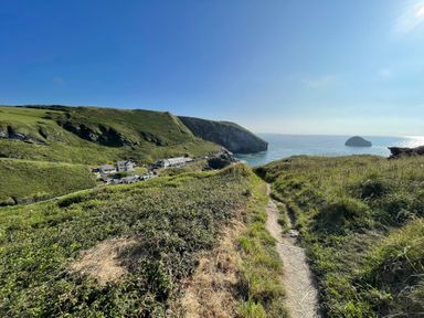 A coastal view with cliffs and a path at Sea Ledge Trebarwith Strand near Tintagel