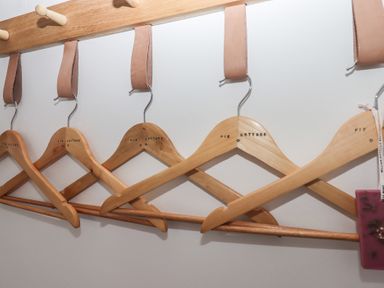 Wooden clothes hangers on a wooden rack at Pie Cottage in Teignmouth