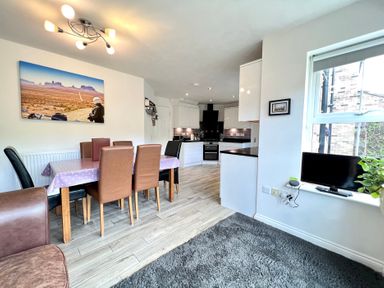 A dining room with a table and chairs at Harefield in Rothbury