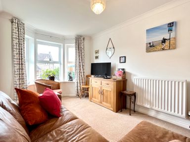 A living room with a sofa and television at Harefield in Rothbury