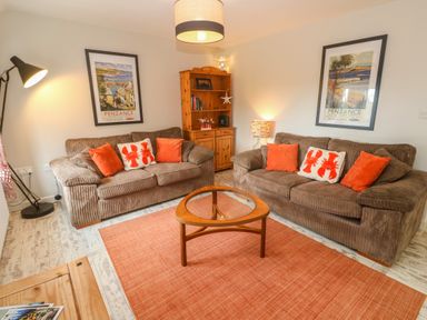 A living room with two sofas and a coffee table at Sea View Loft in Rosudgeon