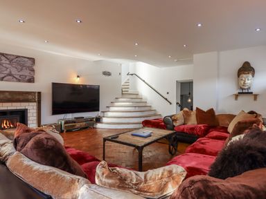 A living room with a sofa and television at Delmonte Lodge in Torquay