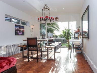 A dining room with a table and chairs at Delmonte Lodge in Torquay