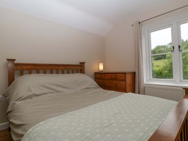 A bedroom with a bed and chest of drawers at 2 Loxter Villas Wellington Heath near Ledbury