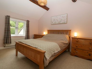 A bedroom with a bed and nightstand at 2 Loxter Villas Wellington Heath near Ledbury
