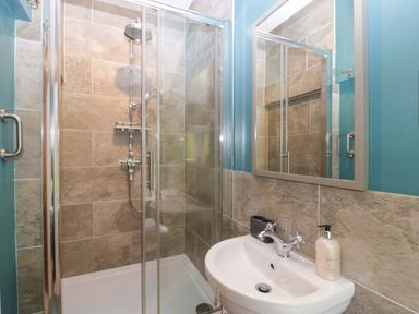 A bathroom with a shower and sink at 2 Loxter Villas Wellington Heath near Ledbury