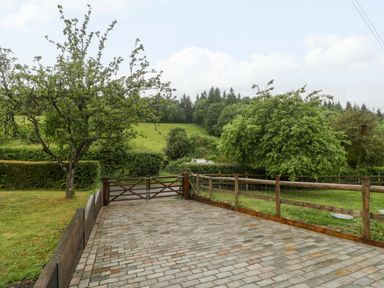 A view of a paved area with trees and a gate at 2 Loxter Villas Wellington Heath near Ledbury