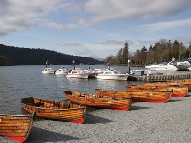 A view of boats at a lake with a gravel beach at Marina View in Bowness-On-Windermere