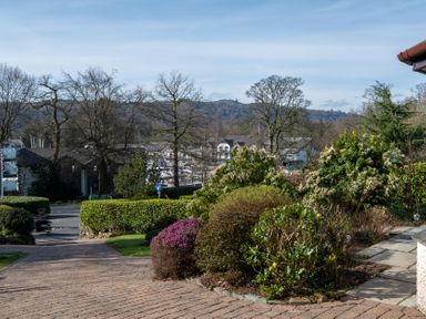 An outdoor area with bushes and trees at Marina View Bowness-On-Windermere