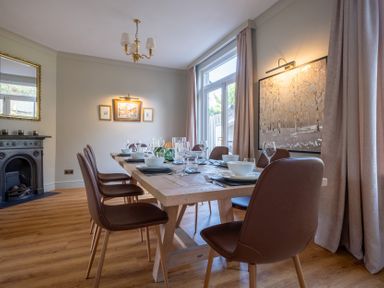 A dining room with a table set for meals at Marina View in Bowness-On-Windermere
