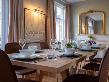 A dining room with a table set for dinner at Marina View in Bowness-On-Windermere