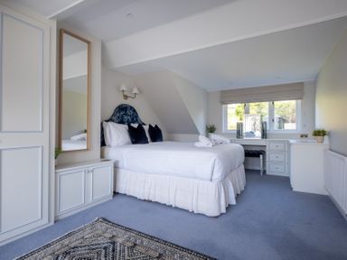 A bedroom with a bed and desk at Marina View in Bowness-On-Windermere