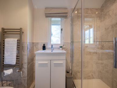 A bathroom with a shower and sink at Marina View in Bowness-On-Windermere